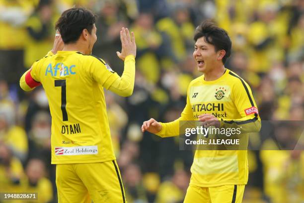 Yusuke Kobayashi of Kashiwa Reysol celebrates with teammate Hidekazu Otani after scoring the team's first goal during the J.League J1 match between...