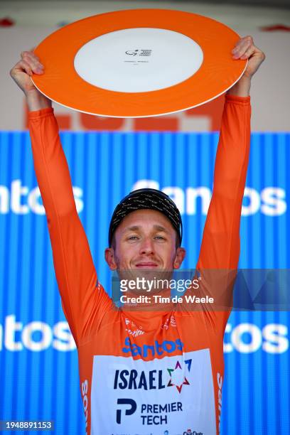 Stephen Williams of United Kingdom and Team Israel - Premier Tech - Orange Santos Leader's Jersey celebrates at podium as overall race winner during...