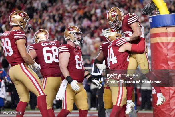 Christian McCaffrey of the San Francisco 49ers celebrates with teammates after scoring a 6-yard rushing touchdown during the fourth quarter against...