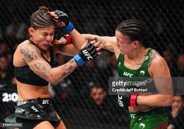 Raquel Pennington punches Mayra Bueno Silva of Brazil in a UFC bantamweight championship bout during the UFC 297 event at Scotiabank Arena on January...