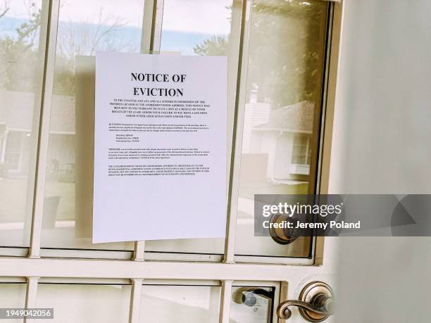 paper eviction notice flyer on the front door of a home in the united states - eviction stock pictures, royalty-free photos & images