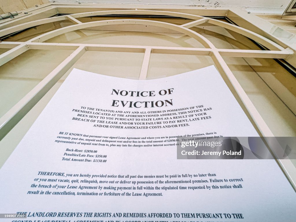 Low Angle View of an Eviction Notice on the Front Door of a Home in a Residential USA Neighborhood