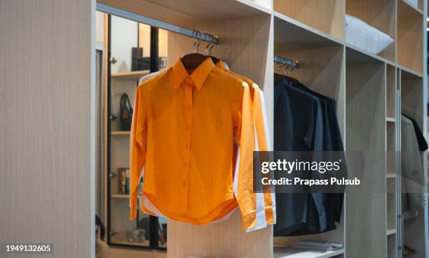 dress shirts hanging in a closet - rack stock pictures, royalty-free photos & images