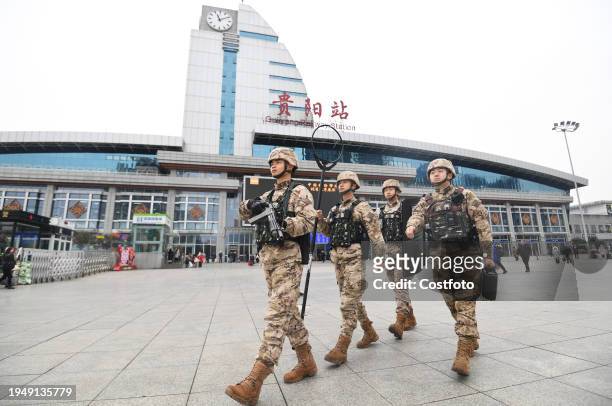 Armed police officers and soldiers patrol the square in front of Guiyang Railway Station in Guiyang, Guizhou province, China, Jan 24, 2024.