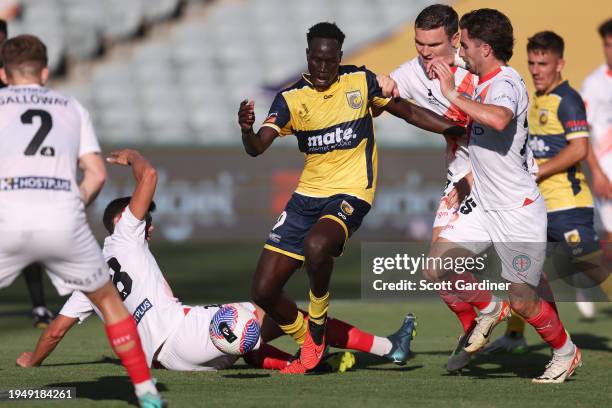 Alou Kuol of the Mariners competes for the ball with Jordon Hall and Curtis Good of Melbourne City during the A-League Men round 13 match between...