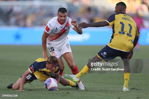 Andrew Nabbout of Melbourne City competes for the ball with Jacob Farrell and Ángel Quiñones of the Mariners during the A-League Men round 13 match...