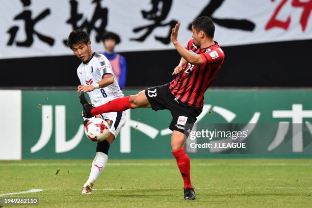 Yoichiro Kakitani of Cerezo Osaka controls the ball against Diego Macedo of Consadole Sapporo during the J.League J1 match between Consadole Sapporo...