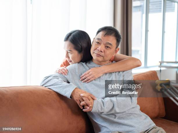 hugging, showing love for disabled man. - ibnjaafar stock pictures, royalty-free photos & images