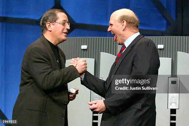 Microsoft CEO Steve Ballmer sticks his tongue out as he shakes hands with Intel COO Paul Otellini during the keynote address for the global launch of...