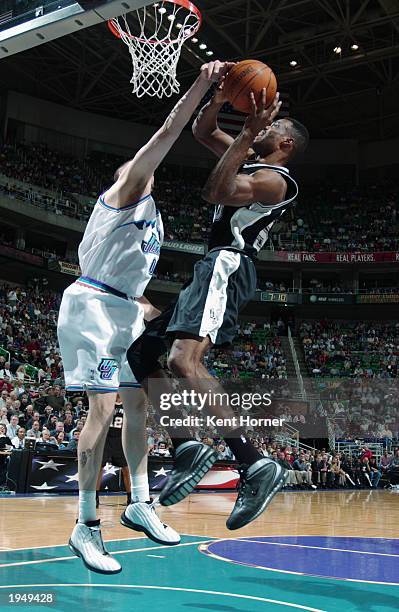 David Robinson of the San Antonio Spurs takes the ball to the basket against Greg Ostertag of the Utah Jazz during the game at Delta Center on April...