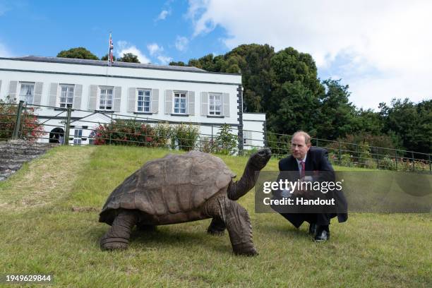 In this handout photo provided by Buckingham Palace, Prince Edward, Duke of Edinburgh seen meeting the world's oldest living land animal, Jonathan...