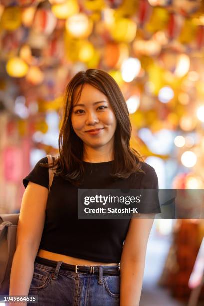 portrait of woman standing on izakaya street, under many lanterns - gold streamer stock pictures, royalty-free photos & images