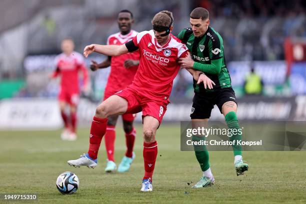 Luca Bazzoli of Muenster challenges Fabian Klos of Bielefeld during the 3. Liga match between Preußen Münster and Arminia Bielefeld at...