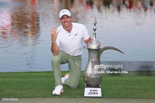 Rory McIlroy of Northern Ireland poses for a photo with the trophy on the 18th green after winning the 2024 Hero Dubai Desert Classic at Emirates...