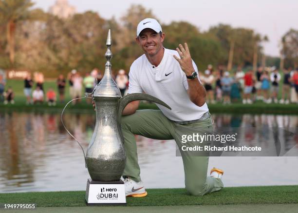 Rory McIlroy of Northern Ireland poses with the trophy, signalling his fourth victory after the final round of the Hero Dubai Desert Classic at...