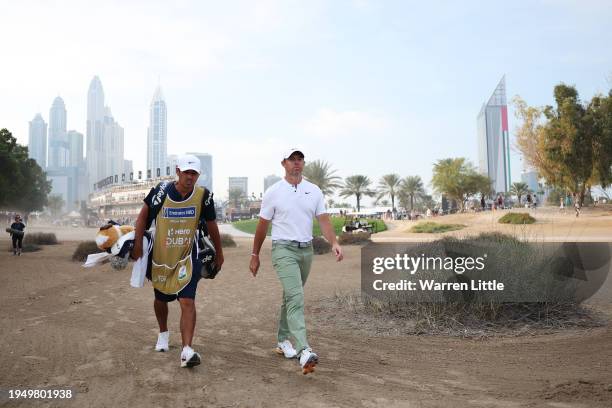 Rory McIlroy of Northern Ireland and his caddie Harry Diamond walk on the 17th hole during the Final Round of the Hero Dubai Desert Classic at...