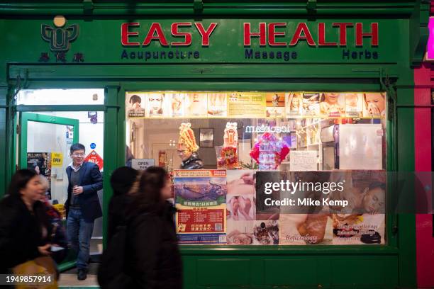 Street scene in Chinatown outside and looking in to a Chinese health, acupuncture, massage and herbs shop on 17th January 2024 in London, United...