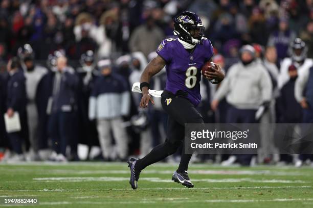Quarterback Lamar Jackson of the Baltimore Ravens rushes with the ball against the Houston Texans during the second quarter in the AFC Divisional...