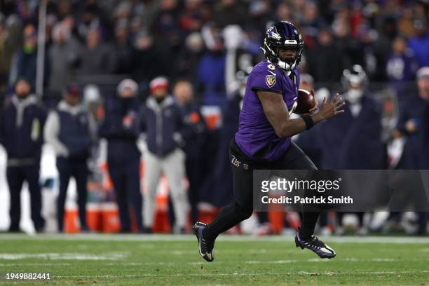 Quarterback Lamar Jackson of the Baltimore Ravens rushes with the ball against the Houston Texans during the second quarter in the AFC Divisional...