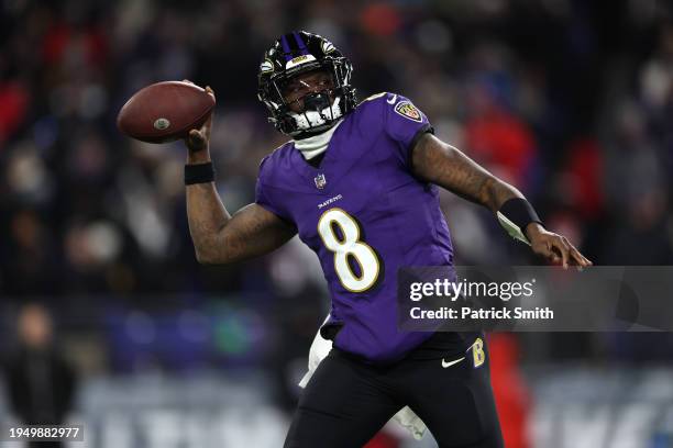 Quarterback Lamar Jackson of the Baltimore Ravens passes the ball against the Houston Texans during the second quarter in the AFC Divisional Playoff...