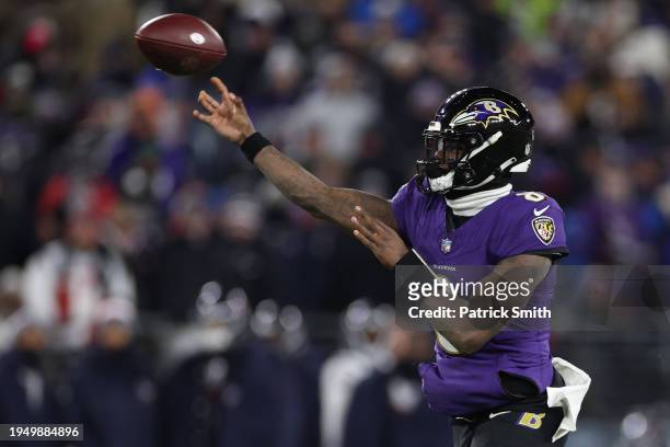 Quarterback Lamar Jackson of the Baltimore Ravens passes against the Houston Texans during the second quarter in the AFC Divisional Playoff game at...