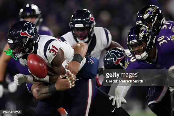 RDameon Pierce of the Houston Texans fumbles the ball on a kick-off return against the Baltimore Ravens in the AFC Divisional Playoff game at M&T...