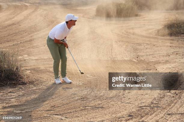 Rory McIlroy of Northern Ireland reacts after playing his second shot on the 16th hole during the Final Round of the Hero Dubai Desert Classic at...