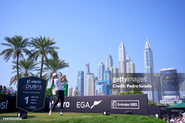 Haotong Li of China tees off on the 1st hole during the final round of the Hero Dubai Desert Classic on the Majlis Course at Emirates Golf Club on...