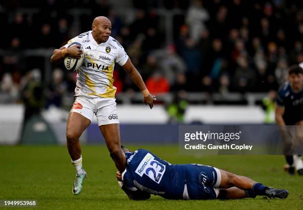 Teddy Thomas of Stade Rochelais is tackled by Telusa Veainu of Sale Sharks during the Investec Champions Cup match between Sale Sharks and Stade...