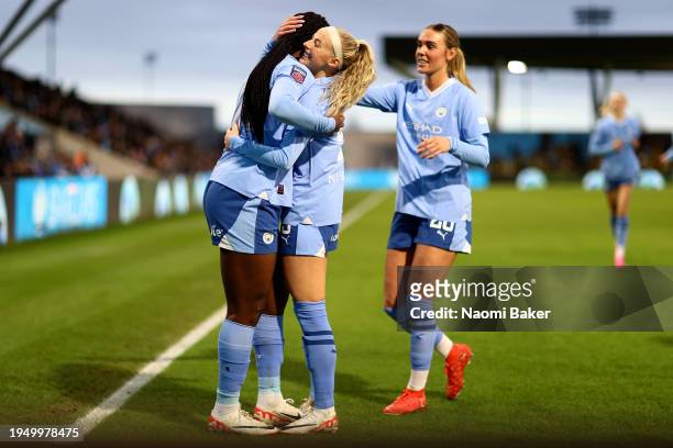 Khadija Shaw of Manchester City celebrates scoring her team's second goal with teammates Chloe Kelly and Jill Roord during the Barclays Women's Super...
