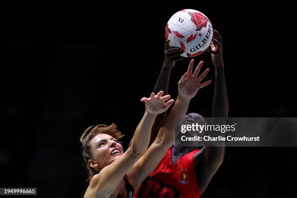 Mary Cholhok of Uganda She Cranes challenges for the ball with New Zealand Silver Ferns Karin Burger during the Vitality Netball Nations Cup match...