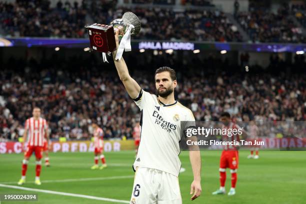 Nacho Fernandez of Real Madrid shows the Spanish Super Cup trophy to the fans prior to the LaLiga EA Sports match between Real Madrid CF and UD...