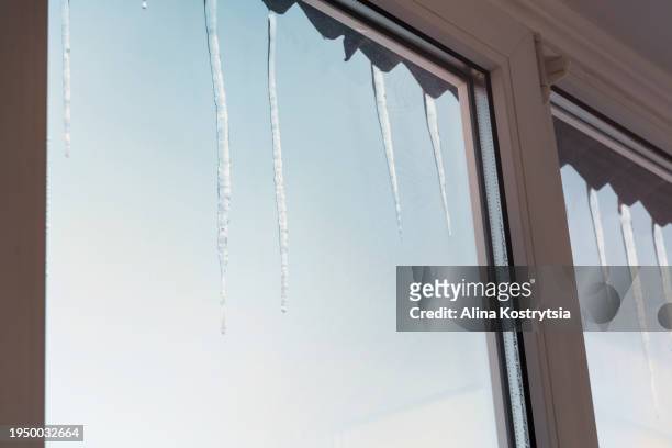 icicles hanging outside window in winter - shaking hangs stock pictures, royalty-free photos & images