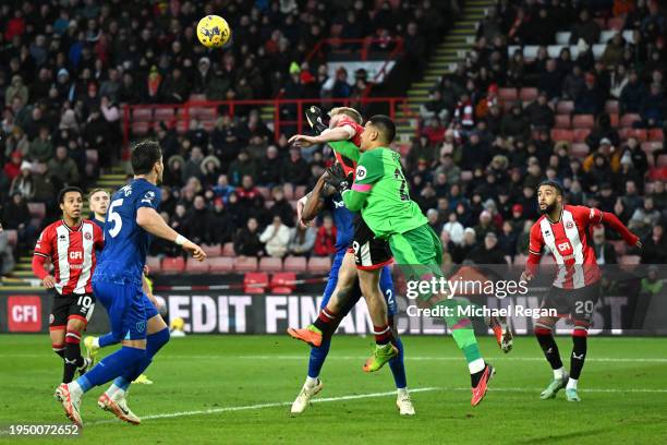 Alphonse Areola of West Ham United fouls Oliver McBurnie of Sheffield United leading to a penalty during the Premier League match between Sheffield...