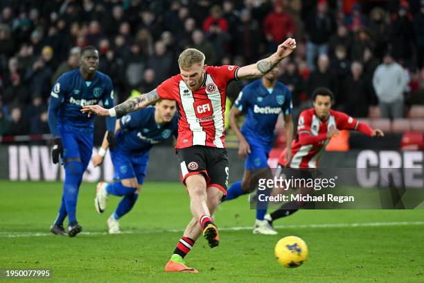 Oliver McBurnie of Sheffield United scores his team's second goal from the penalty spot during the Premier League match between Sheffield United and...