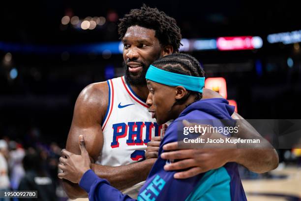 Joel Embiid of the Philadelphia 76ers talks with Frank Ntilikina of the Charlotte Hornets after their game at Spectrum Center on January 20, 2024 in...