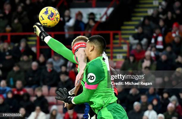 Alphonse Areola of West Ham United fouls Oliver McBurnie of Sheffield United leading to a penalty during the Premier League match between Sheffield...