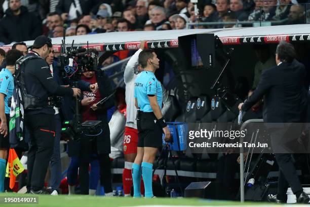 Referee Francisco Jose Hernandez is called to the VAR monitor during the LaLiga EA Sports match between Real Madrid CF and UD Almeria at Estadio...