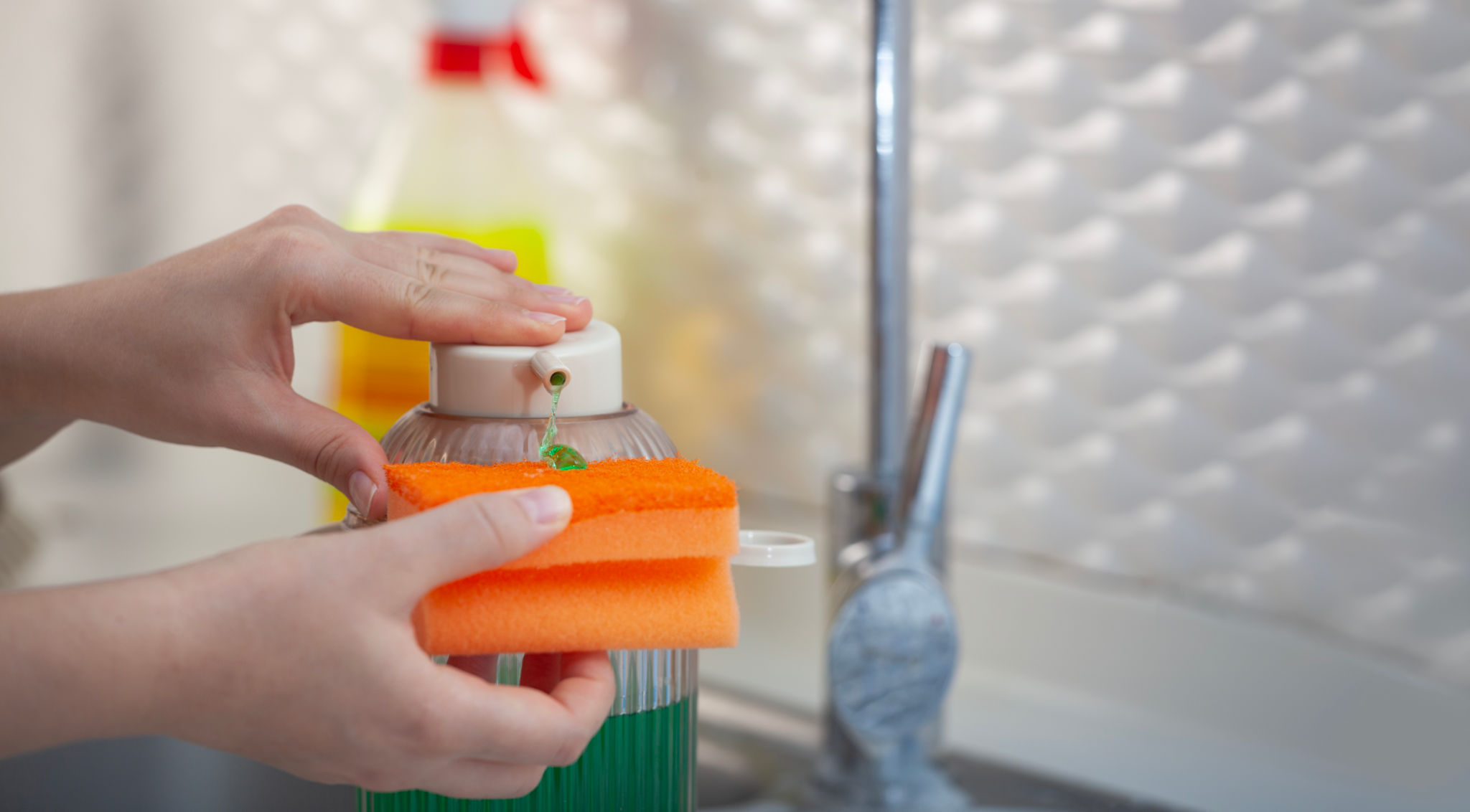 Detergent Bottle and Sponge on Kitchen Table Detergent Bottle and Sponge on Kitchen Table