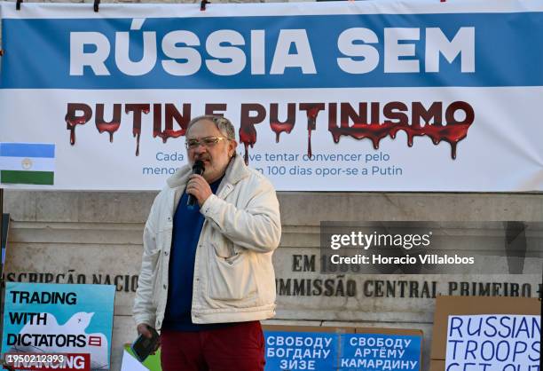 Russian art curator and member of the Anti War Committee Marat Gelman stands in front of a "Russia without Putin and Putinism" banner while while...