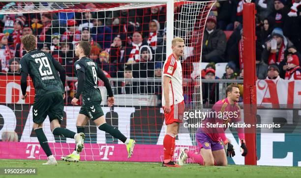 Matthijs de Ligt of FC Bayern Muenchen Manuel Neuer of Bayern Muenchen disappointed after Mitchel Weiser of Werder Bremen scores the goal 0:1 during...