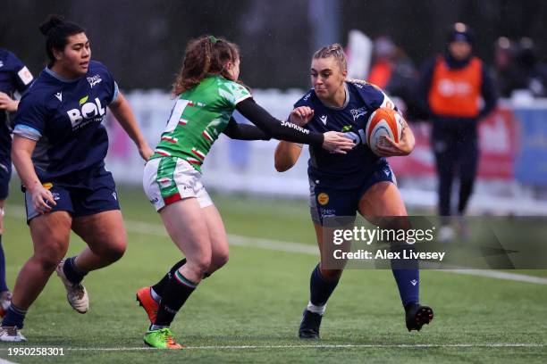 Hollie Bawden of Sale Sharks runs with the ball whilst under pressure from Amy Relf of Leicester Tigers during the Allianz Premiership Women's Rugby...