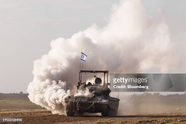 Israeli forces travel towards Gaza in a tank, viewed near the Israel-Gaza border in southern Israel, on Wednesday, Jan. 24, 2024. United Nations...