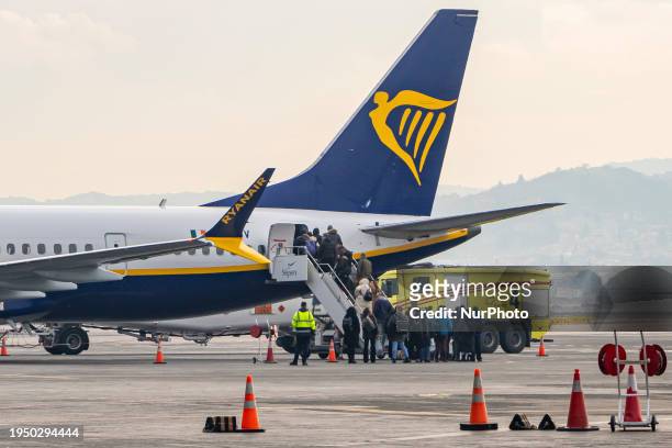 Passengers boarding a Boeing 737 MAX 8-200 passenger airplane of Ryanair low cost airline carrier at Thessaloniki Makedonia International Airport...