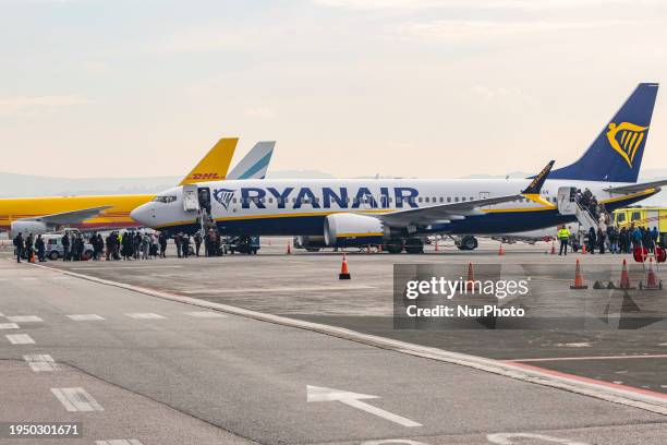 Passengers boarding a Boeing 737 MAX 8-200 passenger airplane of Ryanair low cost airline carrier at Thessaloniki Makedonia International Airport...