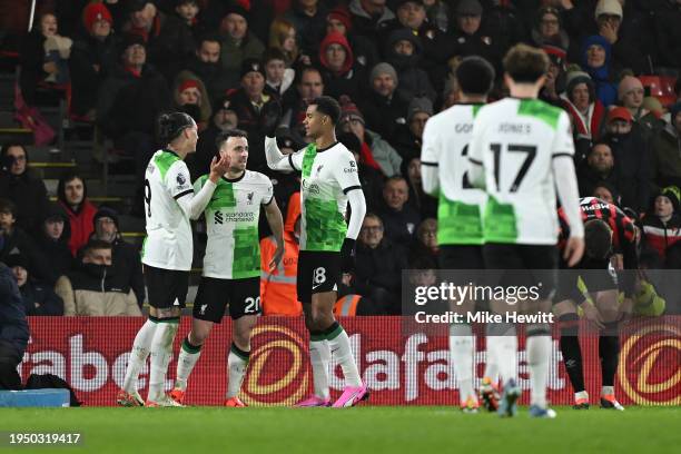 Diogo Jota of Liverpool celebrates scoring his team's second goal with teammates Darwin Nunez and Cody Gakpo during the Premier League match between...