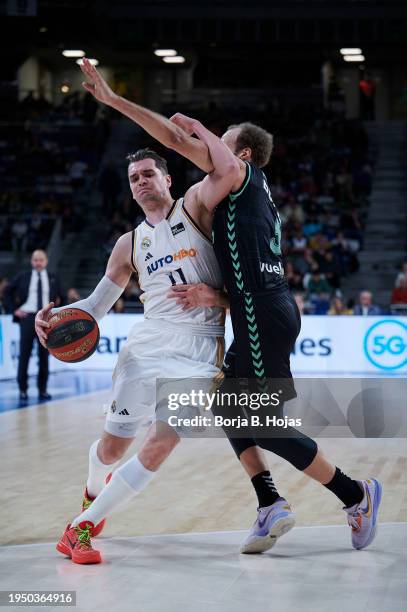 Mario Hezonja of Real Madrid and Denzel Andersson of Bilbao Basket in action during Liga Endesa match between Real Madrid and Bilbao Basket at WiZink...