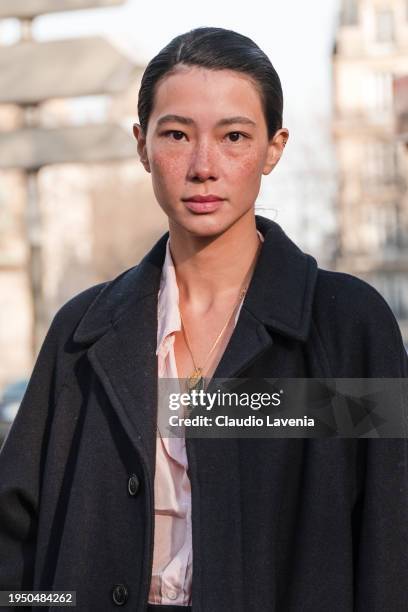 Guest wears pink blouse, black coat, outside Hermes, during the Menswear Fall/Winter 2024/2025 as part of Paris Fashion Week on January 20, 2024 in...