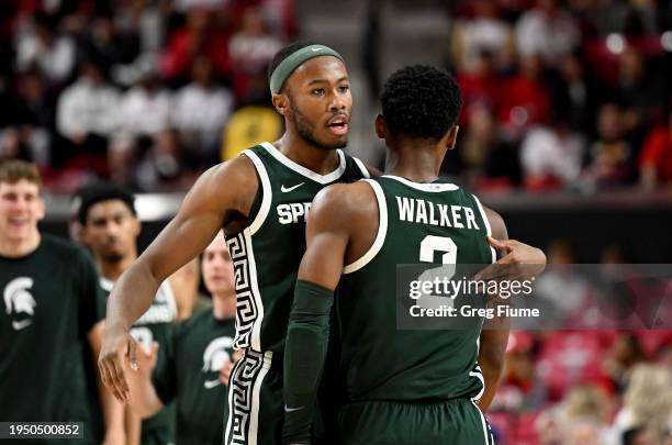 Tre Holloman celebrates with Tyson Walker of the Michigan State Spartans in the second half against the Maryland Terrapins at Xfinity Center on...