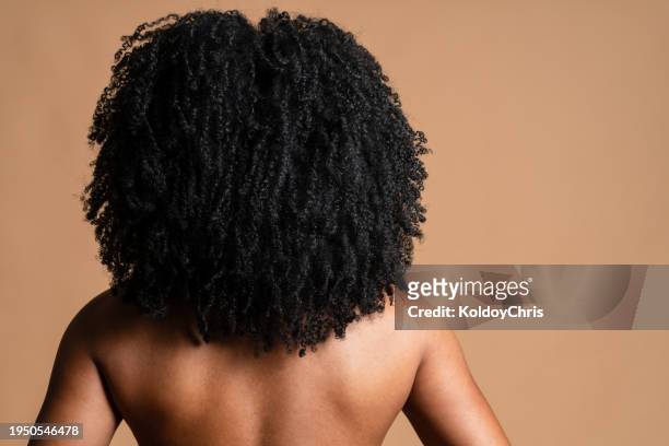 rear view of latin american man with voluminous curly afro on nude back - afro back stock pictures, royalty-free photos & images